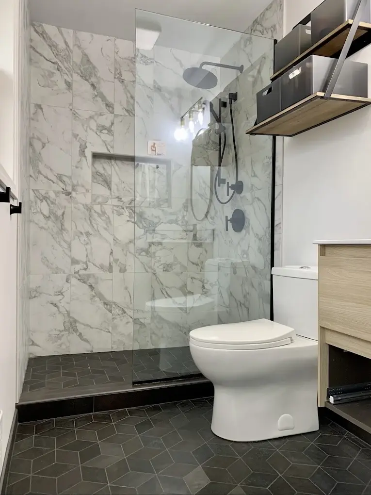 Worker marking measurements on a framed wall