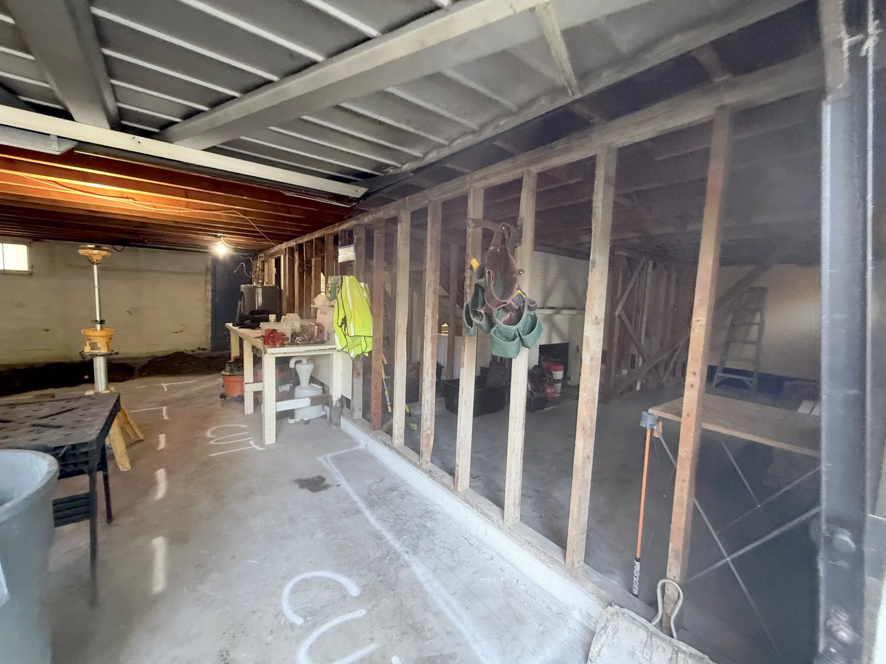Temporary basement support walls with an open work area beyond