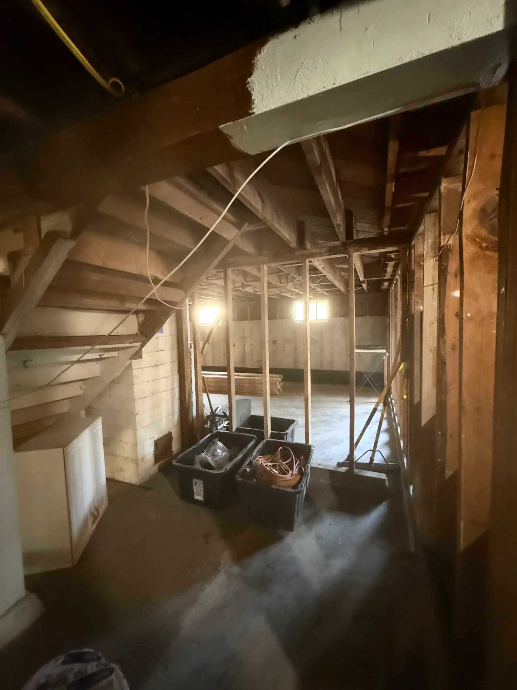 Temporary support walls viewed through the basement stair area