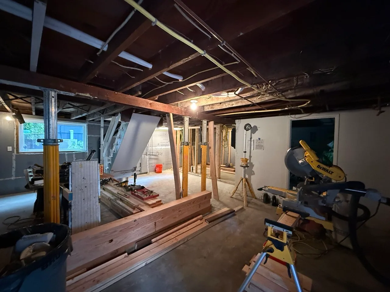 Long foundation wall covered with sealed rigid-foam insulation behind furring and framing