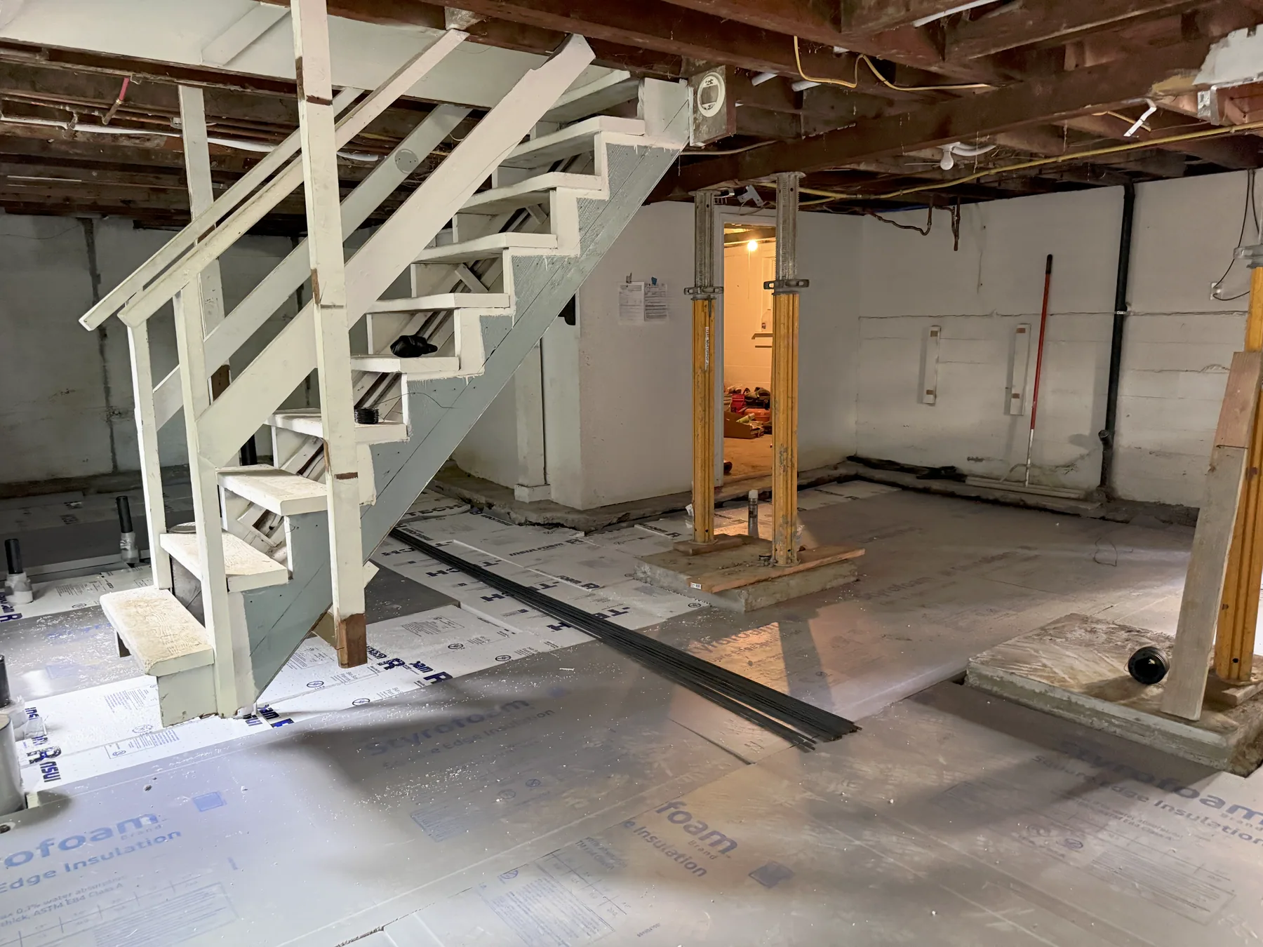 Wide basement floor covered with fitted rigid-insulation panels