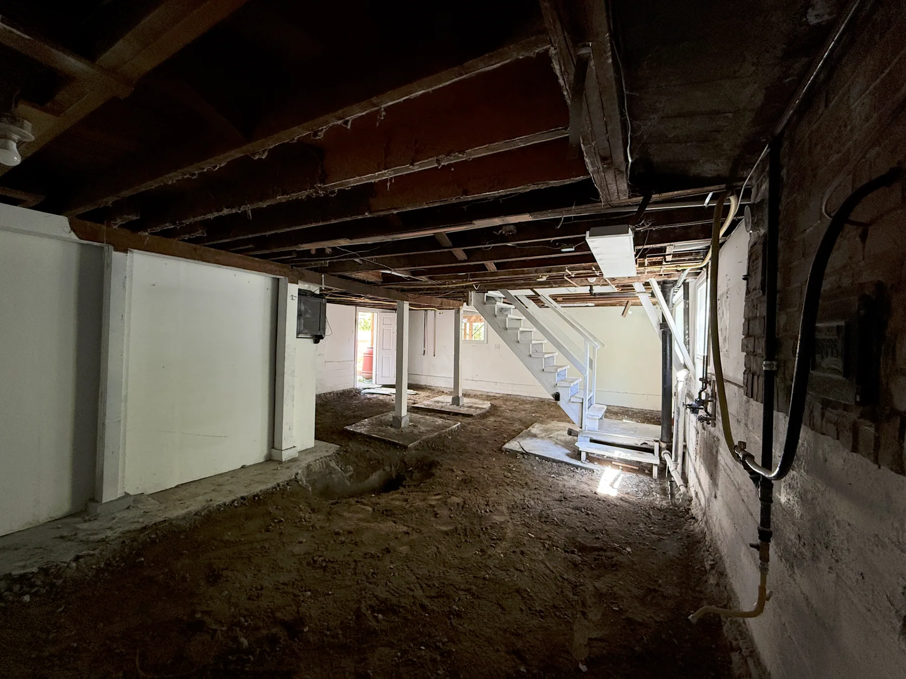 Wide basement view after most of the original concrete floor was removed