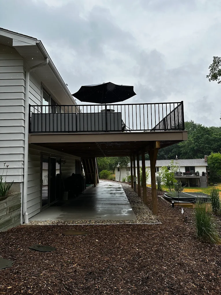 Elevated deck structure and covered patio below