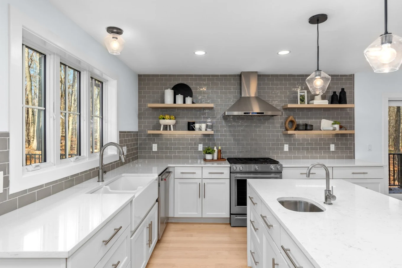 Completed white kitchen with gray tile and oak shelving
