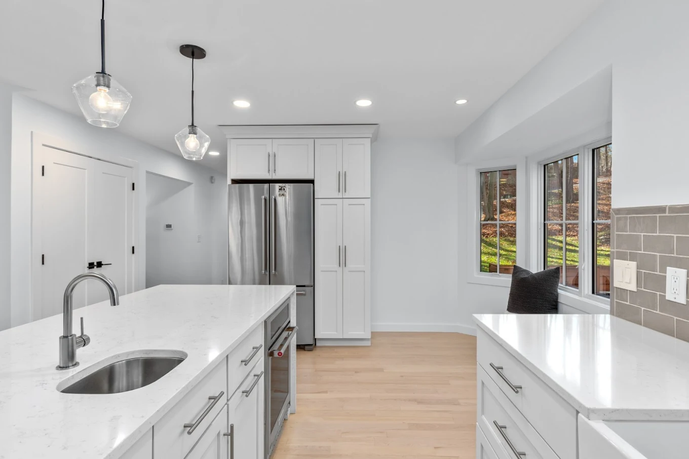 Quartz island and full-height kitchen storage