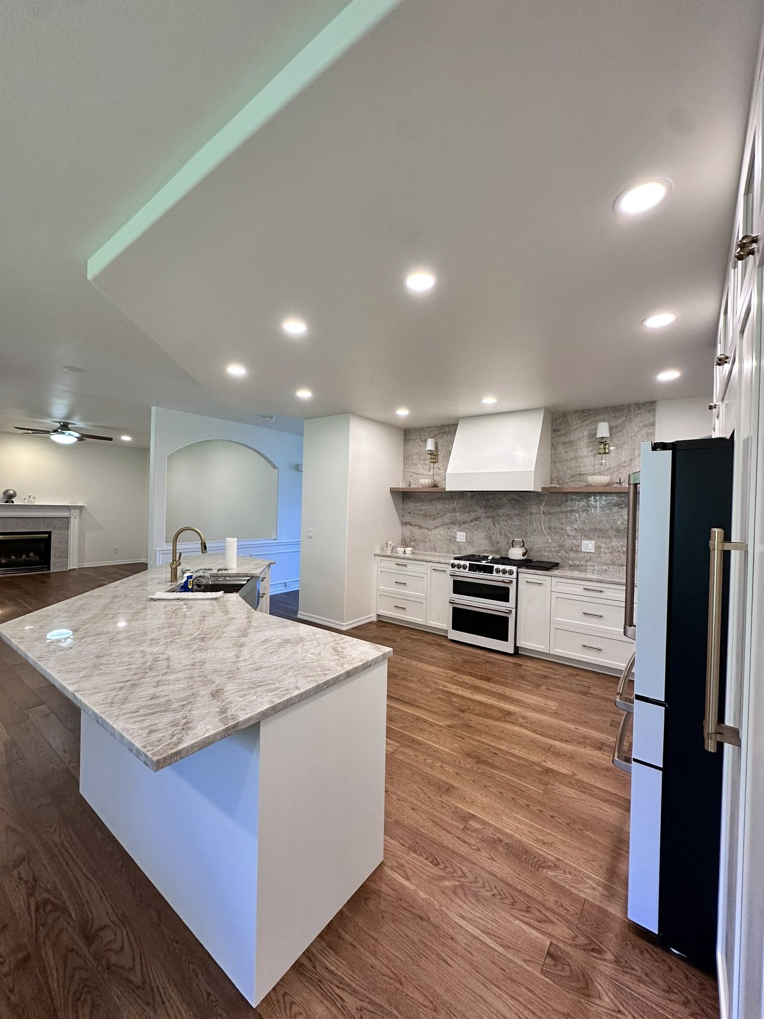 Open kitchen with statement stone and warm flooring