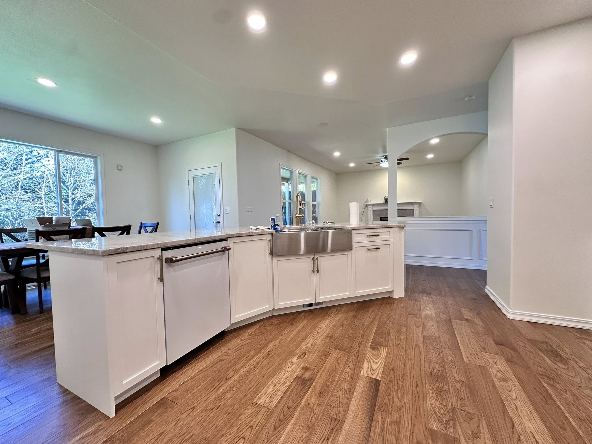 Kitchen island opening toward living and dining spaces