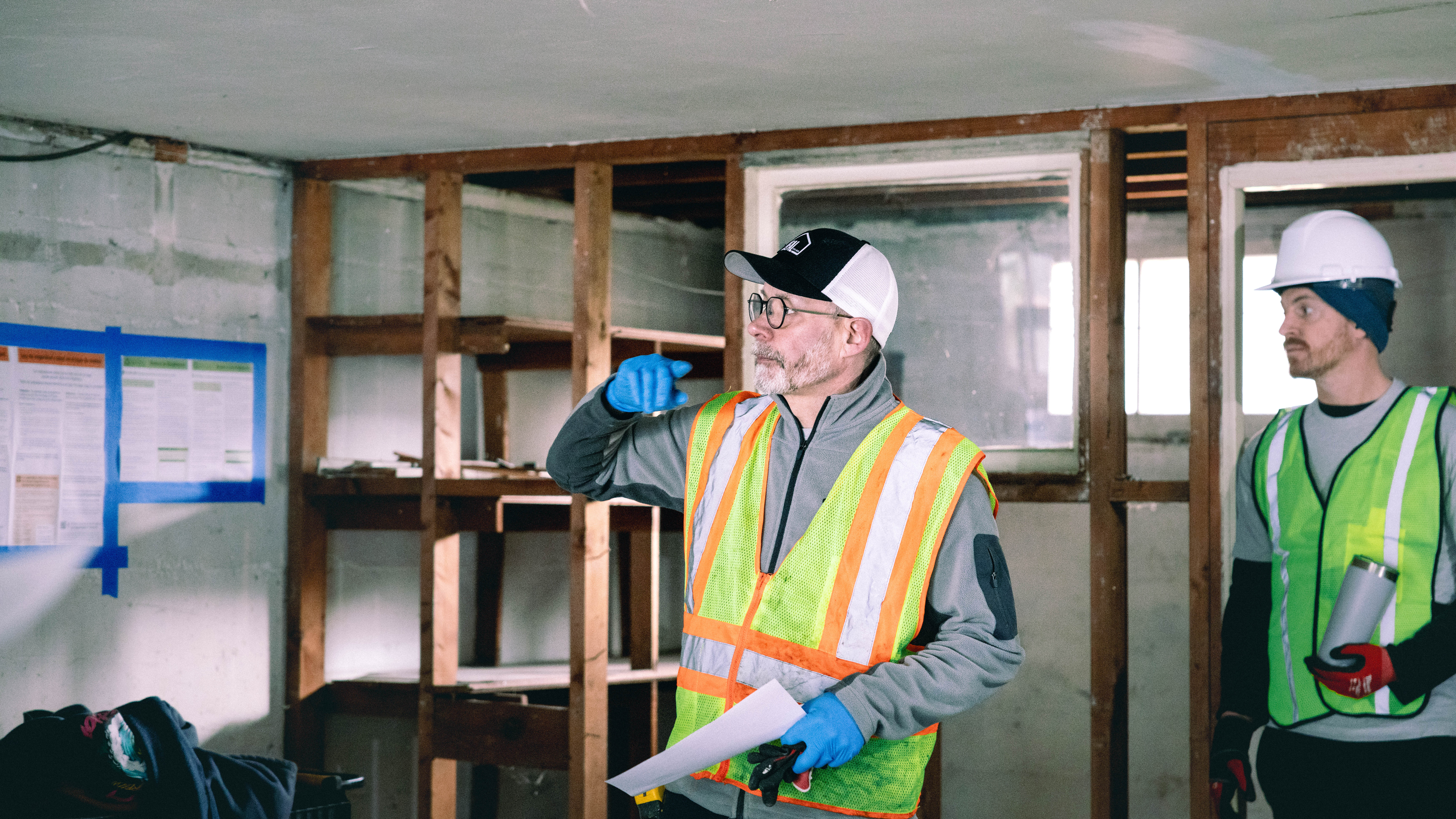 Ideal team reviewing construction drawings on site