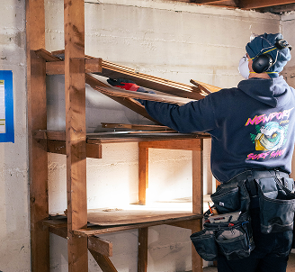 Carpenter cutting framing lumber inside a remodel