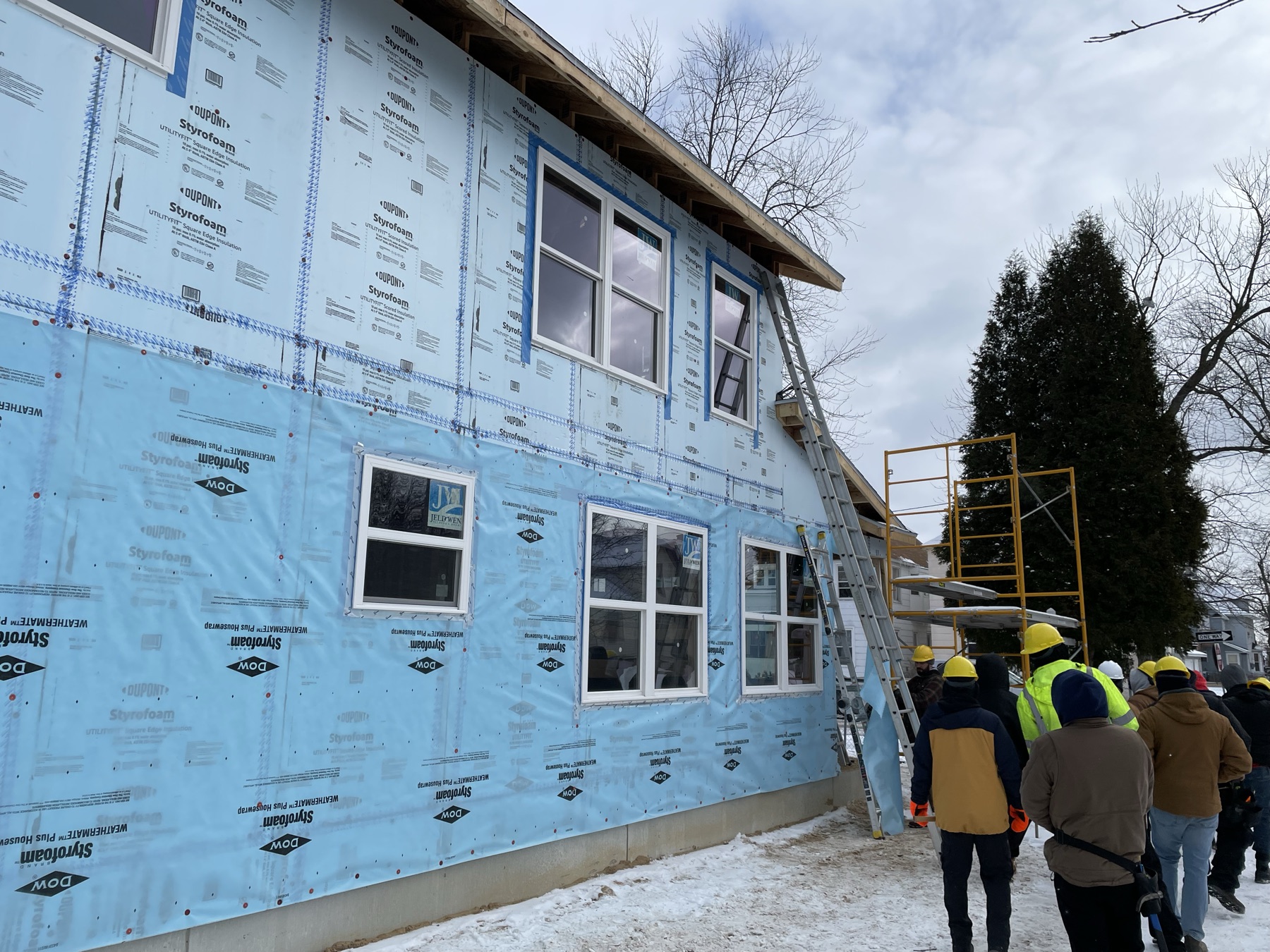 GRCC builders course participants working on a home exterior